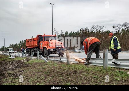 2022-04-09 région de Kiev, Ukraine. Les travailleurs de la route réparent l'autoroute E-40 endommagée après les bombardements russes. La guerre en Ukraine Banque D'Images