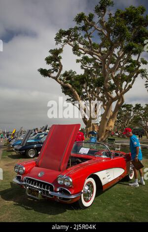 Voiture cabriolet Corvette de Chevrolet rouge, soigneusement analysée par un acheteur potentiel, dans un salon de voitures d'époque à San Diego Marina Banque D'Images