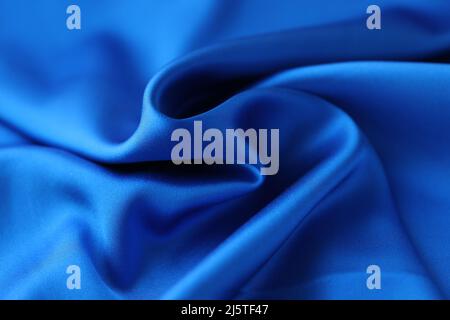 Tissu bleu satiné. Concept de tissu naturel ou de satin de polyester Banque D'Images