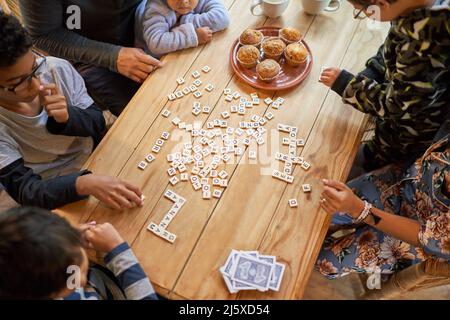 Famille jouant au scrabble à la table à manger Banque D'Images