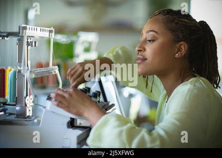 Jeune femme couturière à la machine à coudre Banque D'Images