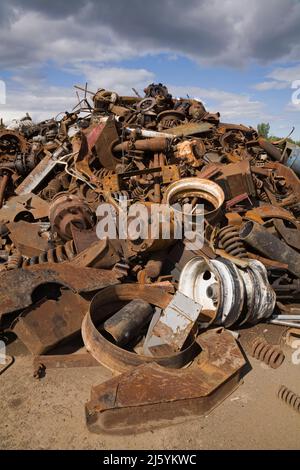 Pile de pièces rouillées et de pièces en métal de résineux mises au rebut dans une cour de recyclage de ferraille. Banque D'Images