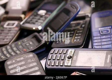 KHARKIV, UKRAINE - 16 DÉCEMBRE 2021 : certains vieux téléphones mobiles obsolètes utilisés de 90s-2000s période. Recyclage de l'électronique sur le marché bon marché Banque D'Images