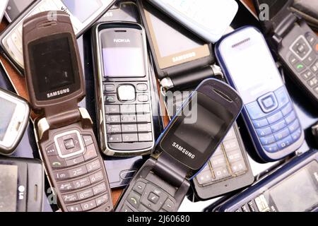 KHARKIV, UKRAINE - 16 DÉCEMBRE 2021 : certains vieux téléphones mobiles obsolètes utilisés de 90s-2000s période. Recyclage de l'électronique sur le marché bon marché Banque D'Images