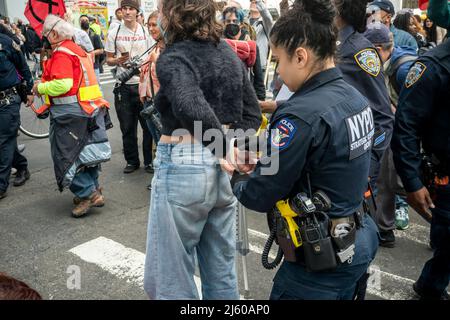 Les activistes de l'environnement affiliés à extinction Rebellion exécutent la désobéissance civile en bloquant la circulation sur la Sixième Avenue à New York le samedi 23 avril 2022. La manifestation a attiré l'attention sur l'inactivité du gouvernement pour mettre fin à la catastrophe climatique, les manifestants ont ensuite été arrêtés (© Richard B. Levine) Banque D'Images