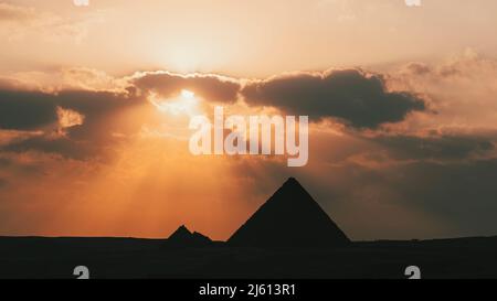 La grande pyramide de Mikerina au Caire, en Égypte. Pyramides de Menkaura contre le ciel nuageux dans la soirée à un beau coucher de soleil Banque D'Images