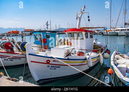 Île d'Aegina, Grèce - 04.27.2022: De beaux petits bateaux de pêche traditionnels grecs au port de l'île d'Aegina amarrés par une journée ensoleillée. Vue colorée Banque D'Images