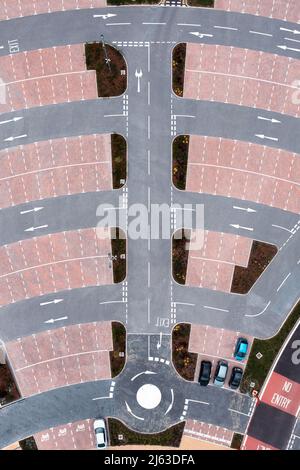 Vue aérienne d'une route complexe dans un parking avec places de parking et flèches directionnelles indiquant la circulation Banque D'Images