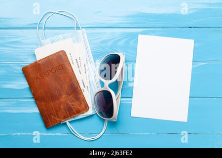 Concept de voyage et de vacances. Accessoires et articles de voyage. Passeport avec billets, lunettes de soleil et masques pour le visage. Vue de dessus plat avec carte vierge pour votre Banque D'Images