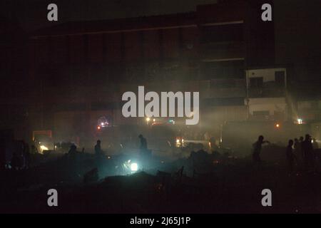 Scène d'un quartier dense où les pompiers et les résidents conduisant la phase de refroidissement et de recherche, après un accident d'incendie ont brûlé des centaines de maisons à Penjaringan, Jakarta Nord, Jakarta, Indonésie. Banque D'Images