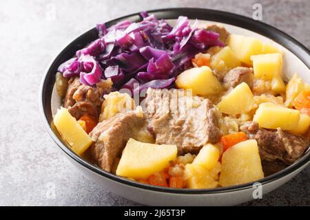 Une maison parfaite avec de la viande et des légumes ragoût de Liverpool en gros plan dans une assiette sur la table. Horizontale Banque D'Images