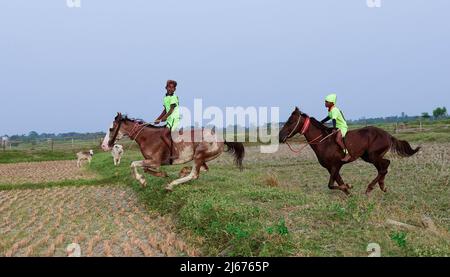 De jeunes jockeys sont à cheval lors d'une course de chevaux en milieu rural. Après les saisons de récolte, les courses de chevaux sont organisées dans ces champs chaque année. Les jockeys qui sont des enfants sont des chevaux sans équipement de protection ou de sécurité. (Photo de Sumit Sanyal/SOPA Images/Sipa USA) crédit: SIPA USA/Alay Live News Banque D'Images