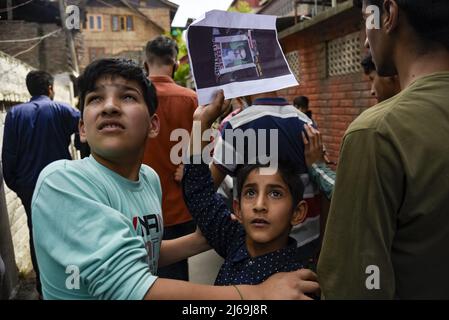 Cachemire, Inde. 29th avril 2022. Un garçon de Kashmiri tient un écriteau comme ils regardent, pendant un rallye marquant Quds (Jérusalem) jour. Une initiative lancée par feu le dirigeant révolutionnaire iranien, l'ayatollah Ruhollah Khomeini, le jour du Qods, se tient chaque année le dernier vendredi du mois musulman à jeun du Ramadan. Crédit : SOPA Images Limited/Alamy Live News Banque D'Images