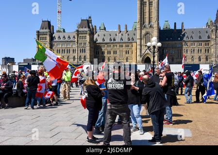 Ottawa, Canada - le 30 avril 2022 : Les manifestants se réunissent sur la colline du Parlement dans le cadre du convoi de motards de Rolling Thunder Ottawa pour protester contre les mandats de vaccination et de masque et le gouvernement en général, les mêmes questions que le convoi de camionneurs plus tôt dans l'année qui a fermé de nombreuses rues et entreprises à Ottawa. Un manifestant peut être vu portant un sweat à capuche du convoi précédent. L'idée originale était d'inonder le centre-ville de motocyclettes, mais la police est intervenue pour empêcher que cela ne se produise. Banque D'Images