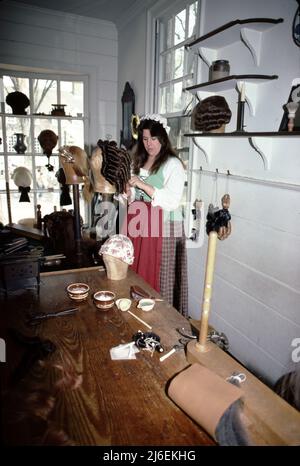 Williamsburg va Etats-Unis 9/1987. Le fabricant de perruques colonial de Williamsburg a servi aux juges, aux procureurs et aux riches. Perukes faits à la main (perruques), files d'attente (morceaux de cheveux accrochés à l'arrière de la tête) et ont façonné les cheveux de l'élite. La propriété d'une perruque ou de plusieurs perruques était un signe de statut en Amérique coloniale. Banque D'Images