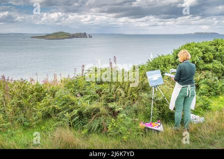 Dublin, Irlande, août 2019 une femme peint sur toile Irelands Eye Island tout en plein air sur Howth Cliff Walk Banque D'Images