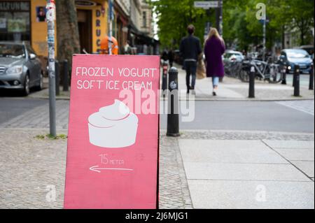 PRODUCTION - 28 avril 2022, Berlin: À Prenzlauer Berg, il y a un signe qui dit "yogourt glacé - crème glacée douce". Beaucoup de gens sont familiers avec le fait que les villes et les villages deviennent d'abord plus beaux, puis plus chers. Mais comment pouvez-vous dire aujourd'hui qu'une région est de plus en plus haut de gamme? Venez d'abord les étudiants et les artistes, puis les cafés et les restaurants. Le grand salon de crème glacée aux saveurs telles que pomme-basilic ou banane-pecan-chèvre lait-caramel. (À dpa: 'Première hanche, puis cher - Comment reconnaître le changement dans la ville') photo: Christophe bateau/dpa Banque D'Images