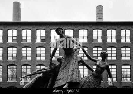 Une sculpture spectaculaire de Mico Kaufman (1989) de travailleurs d'usine datant de 19th ans qui se sont surchargés de leurs luttes avec les usines de textile d'époque en arrière-plan. Ma Banque D'Images