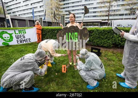 Ocean Rebellion démonstrateur portant un écriteau de nuages qui dit : le GNL est accusé par les enquêteurs de la criminalité climatique de pollution de la planète vue pendant le Global LNG Bankering Summit. Lors du Global LNG Bankering Summit 2022, l'industrie déclare que le GNL ou le gaz naturel liquéfié est le combustible marin le plus propre disponible par rapport au mazout lourd. Le GNL est une technologie sûre, qui permet de réduire considérablement les émissions de CO2 et les émissions quasi inexistantes de particules. Il offre une teneur énergétique plus élevée et des coûts d'exploitation plus faibles. Le but de la conférence de 3 jours est de lancer le démarrage du gaz naturel liquide ( Banque D'Images