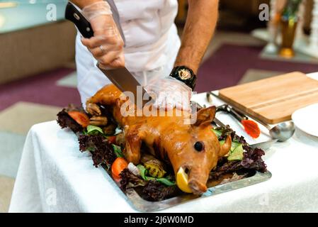 Rôti de porc. Porcelet rôti avec légumes sur le plateau. Banque D'Images