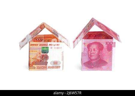 Maisons de monnaie en roubles et en yuans, isolées sur fond blanc Banque D'Images