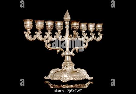 Lampe Hanoukkah (Hanoukkah menorah), en métal, gros plan, sur fond noir. Banque D'Images