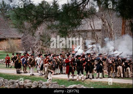 Les personnages de la reconstitution de Minuteman ont eu le feu lors de la reprise des soldats de Redcoat sur Battle Road, devant les troupes de Lexington, Massachusetts, pendant Patriots Da Banque D'Images