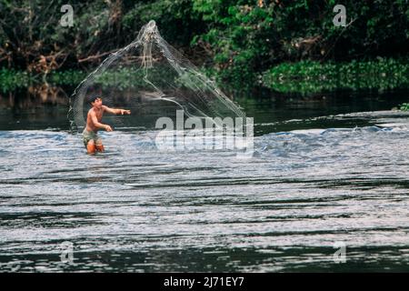 Un Indien jette son filet de pêche dans la rivière Amazone au Brésil. 2010. Banque D'Images