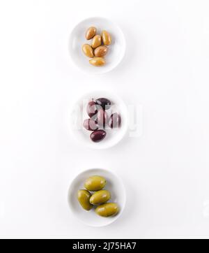 Trois types d'olives dans de petits plats blancs Banque D'Images