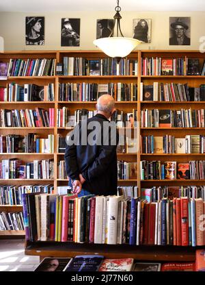 Un client utilise des étagères de livres à vendre dans la célèbre boutique City Lights Booksellers de San Francisco, en Californie. Banque D'Images