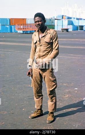 Portrait complet d'un travailleur masculin sur les quais de Dakar, Sénégal, Afrique, 1978 Banque D'Images