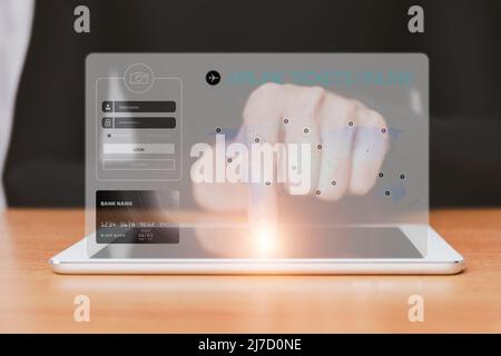 Homme pointe la tablette avec l'application de recherche de billets d'avion sur l'écran. Demande de réservation de billets d'avion en ligne sur tablette. Banque D'Images