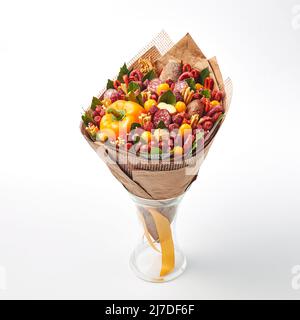 Bouquet de saucisse de différents types et fromage, enveloppé dans du papier artisanal dans un vase sur fond blanc Banque D'Images