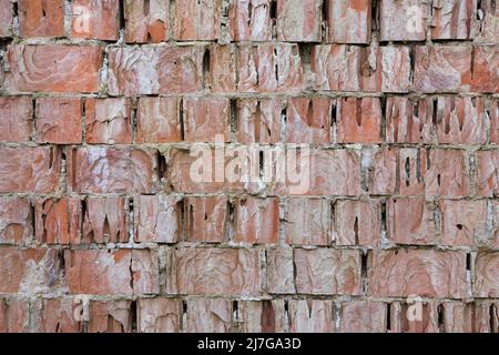 Mur de briques très endommagé. Texture d'arrière-plan. Banque D'Images