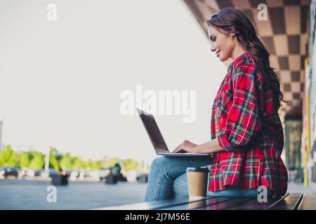 Profil vue latérale portrait d'une fille attirante et qualifiée utilisant l'ordinateur portable écrire e-mail passer la journée ensoleillée à l'extérieur Banque D'Images