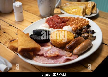 Un petit déjeuner anglais complet - également appelé « friture » - composé d'œufs, saucisses, bacon, tomates, champignons, haricots, pain frit, pot de haschbruns Banque D'Images