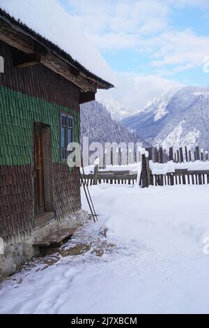 Maison traditionnelle en bois pendant l'hiver dans un village de montagne dans les Carpates, Roumanie Banque D'Images