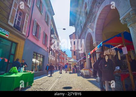 BELLINZONA, SUISSE - 19 MARS 2022 : l'étroite rue médiévale avec des stands de fermiers du marché du samedi dans la ville, le 19 mars à Bellinzona, S. Banque D'Images