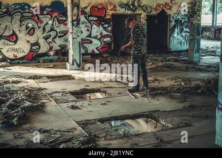 Airsoft sgrungeier dans le bâtiment de l'industrie du grunge. Banque D'Images