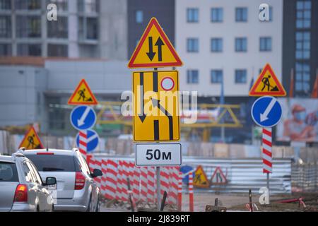 Les travaux routiers avertissent les véhicules des travaux de construction sur la rue de la ville et des voitures qui se déplacent lentement Banque D'Images