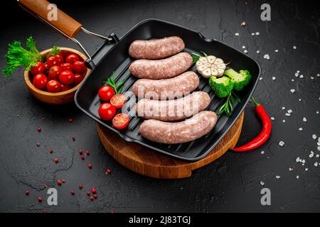 Repas d'été. Faites cuire des saucisses maison avec des légumes sur un gril. Banque D'Images