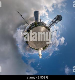 BATUMI, GÉORGIE - SEPTEMBRE 2021 : petite planète dans un ciel bleu avec des nuages dans le centre-ville près des gratte-ciels modernes ou des immeubles de bureaux. Transformation de sp Banque D'Images