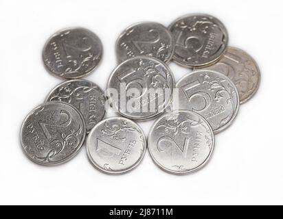 Pile de roubles russes métalliques sur fond blanc. Inflation, hausse des prix, crise économique. Monnaie russe pièces. La valeur nominale des pièces roubles Banque D'Images