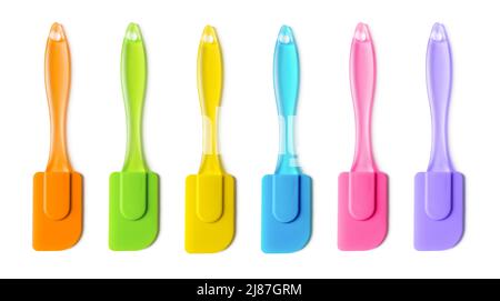 Ensemble de spatules de cuisson en silicone multicolore isolées sur fond blanc. Spatules en caoutchouc colorées avec manche pour la confiserie, la boulangerie et la pâtisserie. Banque D'Images