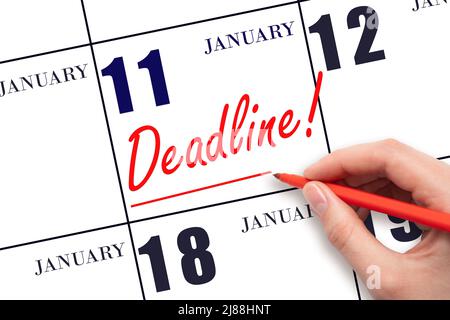 11th jour de janvier. Dessiner à la main une ligne rouge et écrire le texte Date limite le 11 janvier. Mot d'échéance inscrit au calendrier mois d'hiver, Banque D'Images