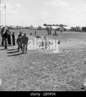 Temps de marbre dans le camp de travail migratoire de l'Administration de la sécurité agricole (AAS) (situation d'urgence.) Beaucoup d'espace pour jouer et beaucoup de compagnons pour les enfants pendant la récolte de pois. Près de Calipatria, Imperial Valley, Californie. Banque D'Images