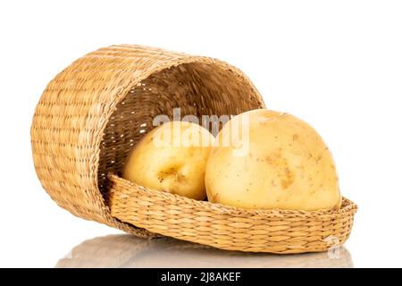 Deux pommes de terre biologiques crues avec un panier de paille, en gros plan, isolées sur fond blanc. Banque D'Images