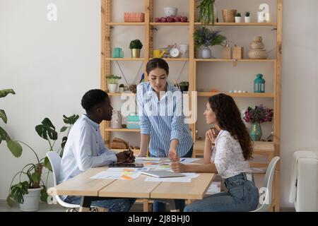 Jeunes femmes d'entreprise entraînent des stagiaires de formation, expliquant la paperasserie Banque D'Images