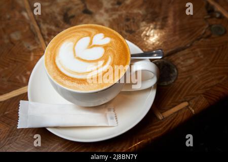 Une tasse de café ou un Latte à motif coeur dans une tasse blanche Banque D'Images