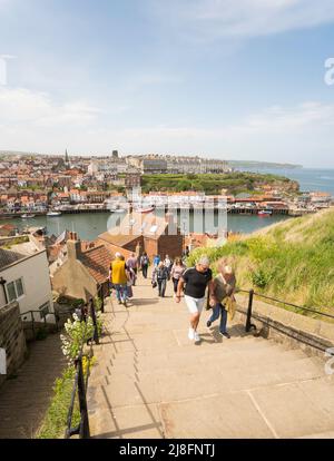 Personnes grimpant sur les marches de l'abbaye de Whitby, Yorkshire, Angleterre, Royaume-Uni Banque D'Images